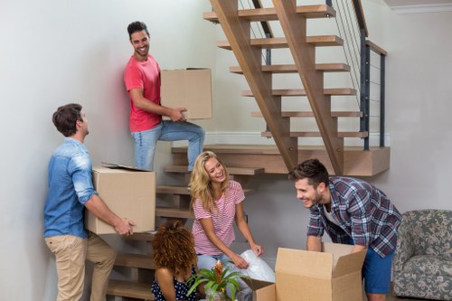 Professional removal company moving boxes in a Belgravia townhouse