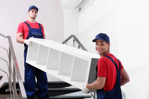 Professional movers assessing a property layout for safe handling