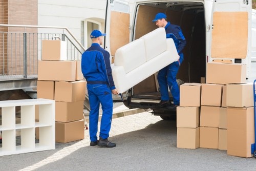 Specialist movers handling a piano in a Belgravia property