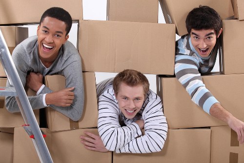 Piano moving team navigating a tight staircase in Belgravia